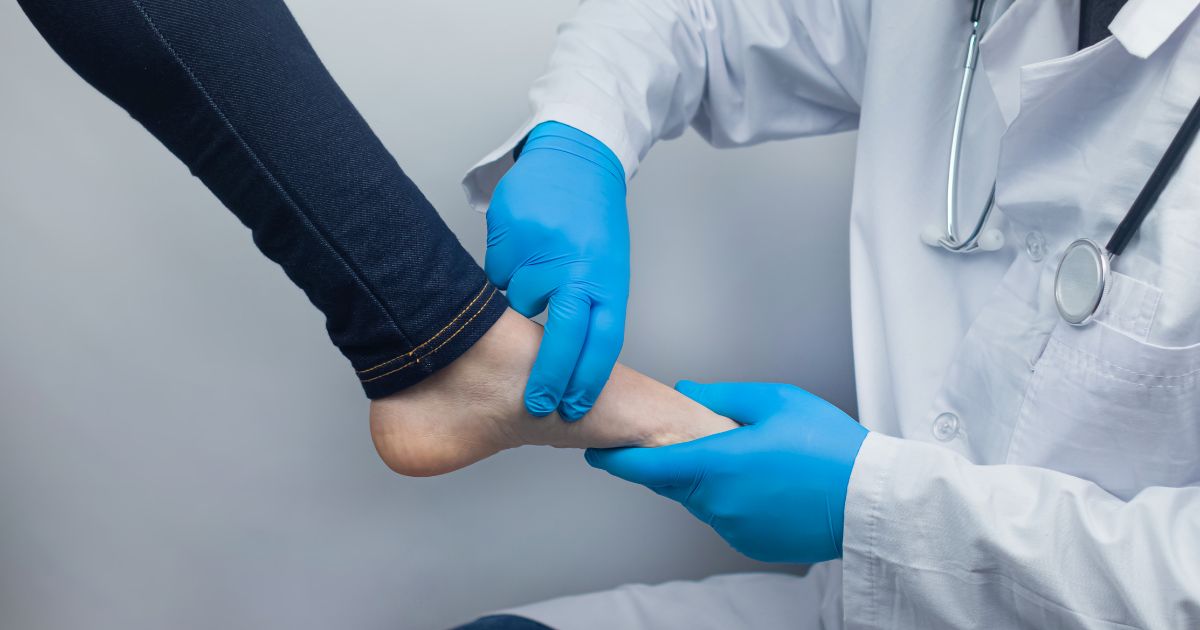 Patient having foot examined by doctor